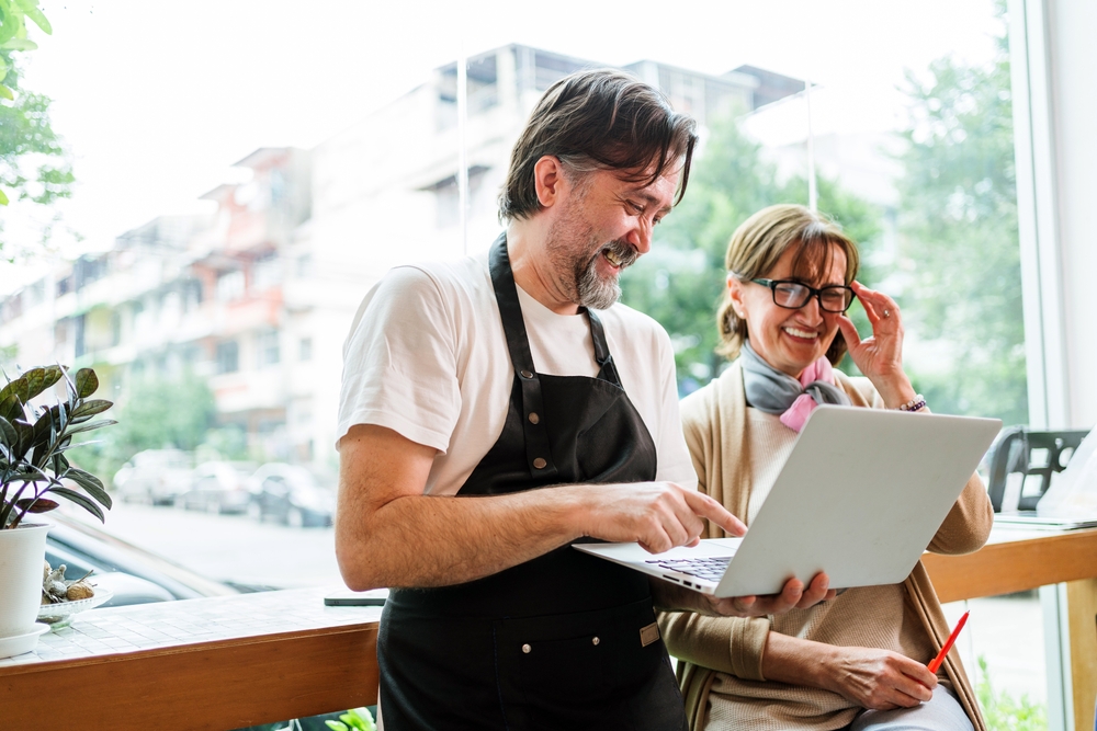 Two people discussing work outdoors