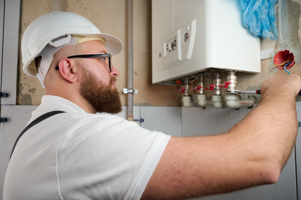 A heating engineer working on a boiler