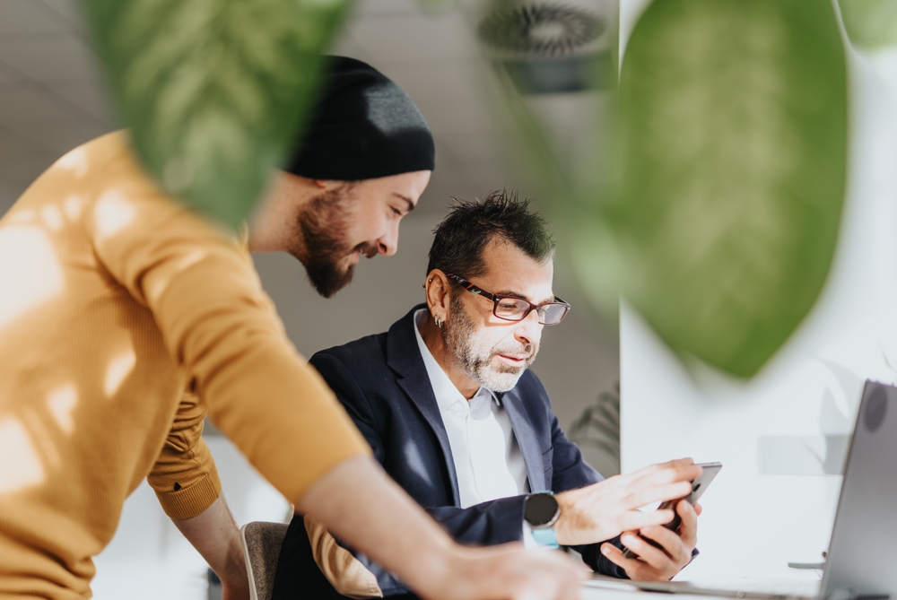 Two business owners reviewing ideas together on a tablet